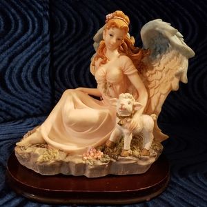 Angel sitting with a lamb